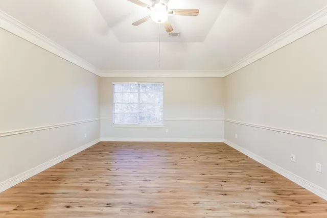 wooden floor in an empty room with a window