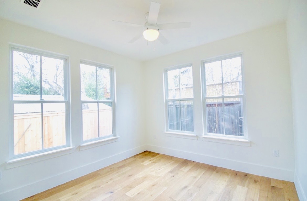 1903 West 30th Street Austin, TX 78703 - Photo 6 of 12 an empty room with wooden floor and windows