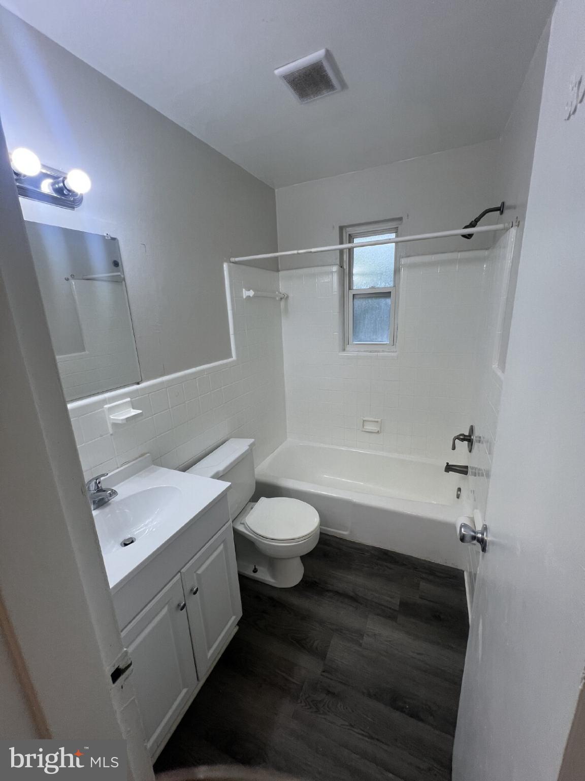 14404 Gemstone Drive, Unit 302 Woodbridge, VA 22191 - Photo 12 of 16 a bathroom with a sink a toilet and shower