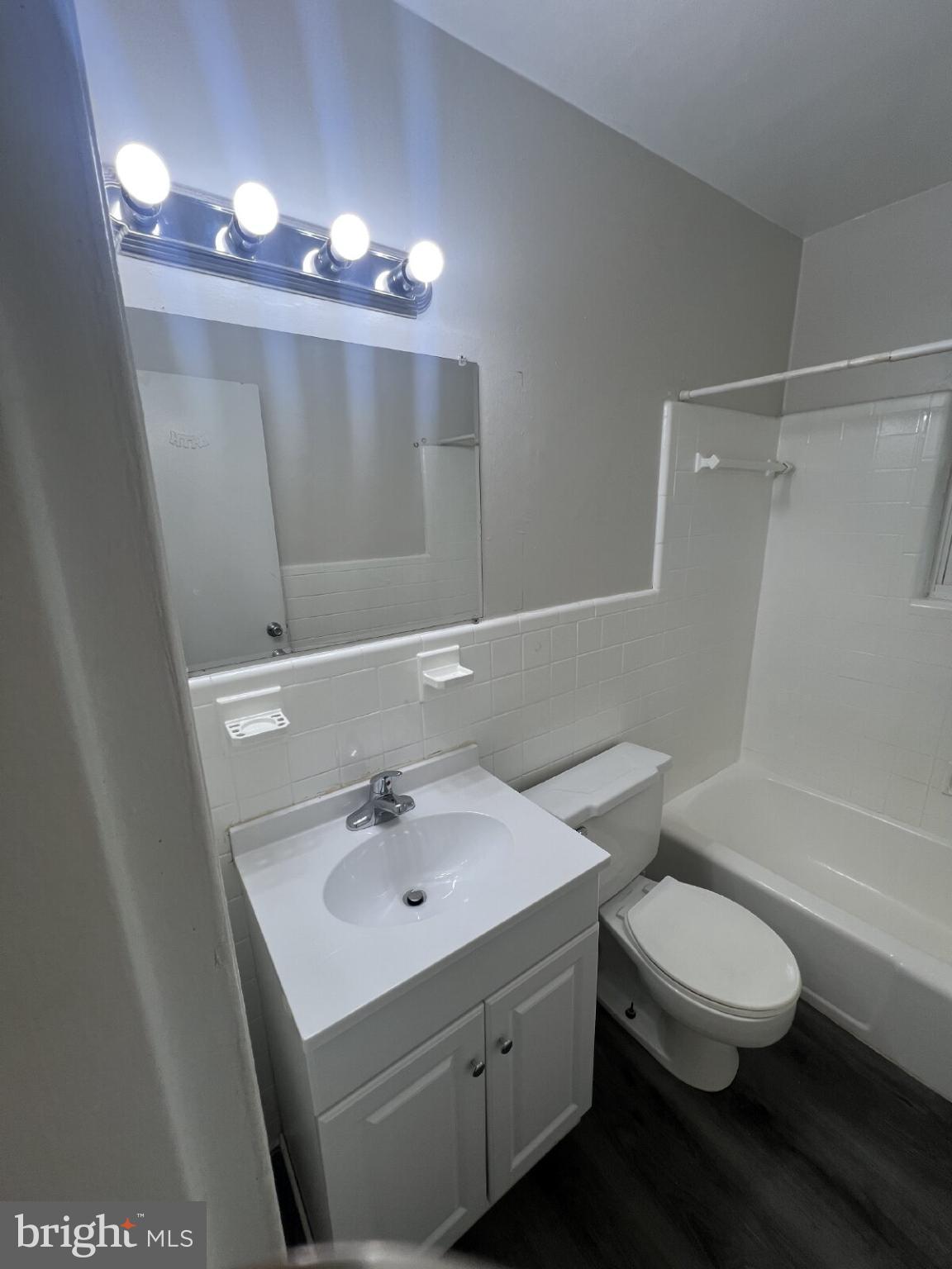 14404 Gemstone Drive, Unit 302 Woodbridge, VA 22191 - Photo 13 of 16 a bathroom with a sink a toilet a mirror and shower