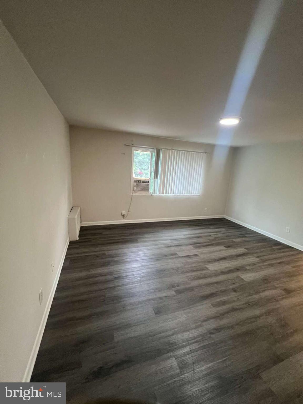 14404 Gemstone Drive, Unit 302 Woodbridge, VA 22191 - Photo 3 of 16 an empty room with wooden floor and windows