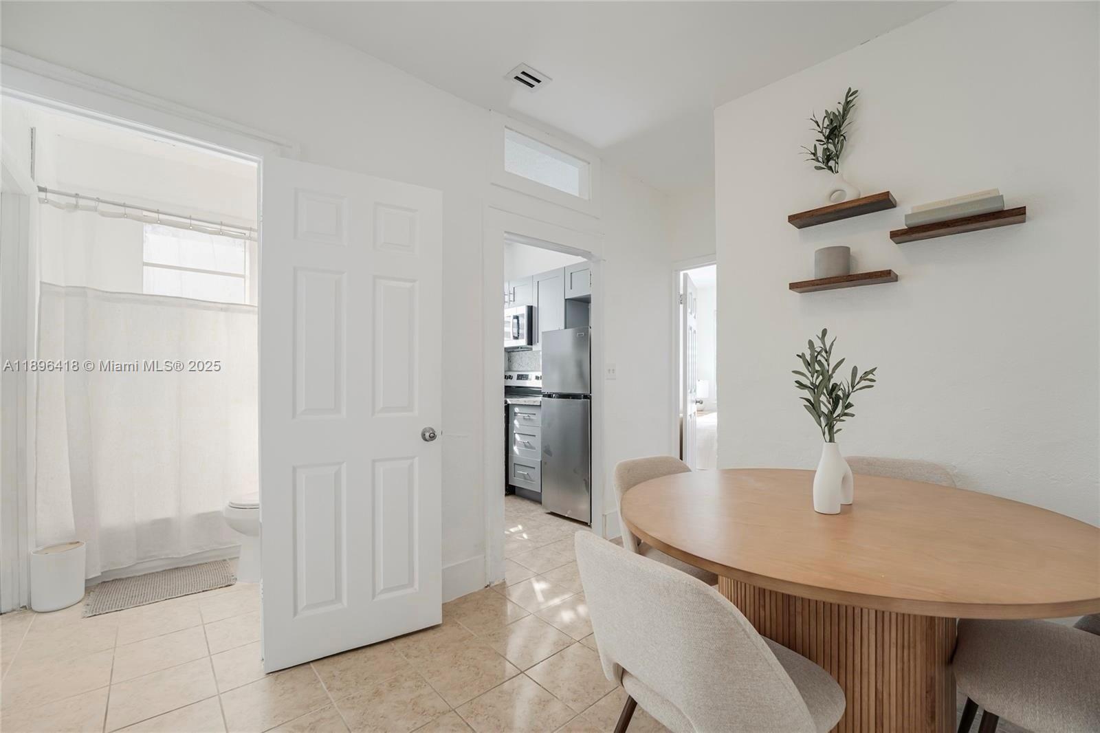 301 Southwest 10th Avenue, Unit 8 Miami, FL 33130 - Photo 2 of 14 a kitchen with stainless steel appliances a refrigerator and cabinets