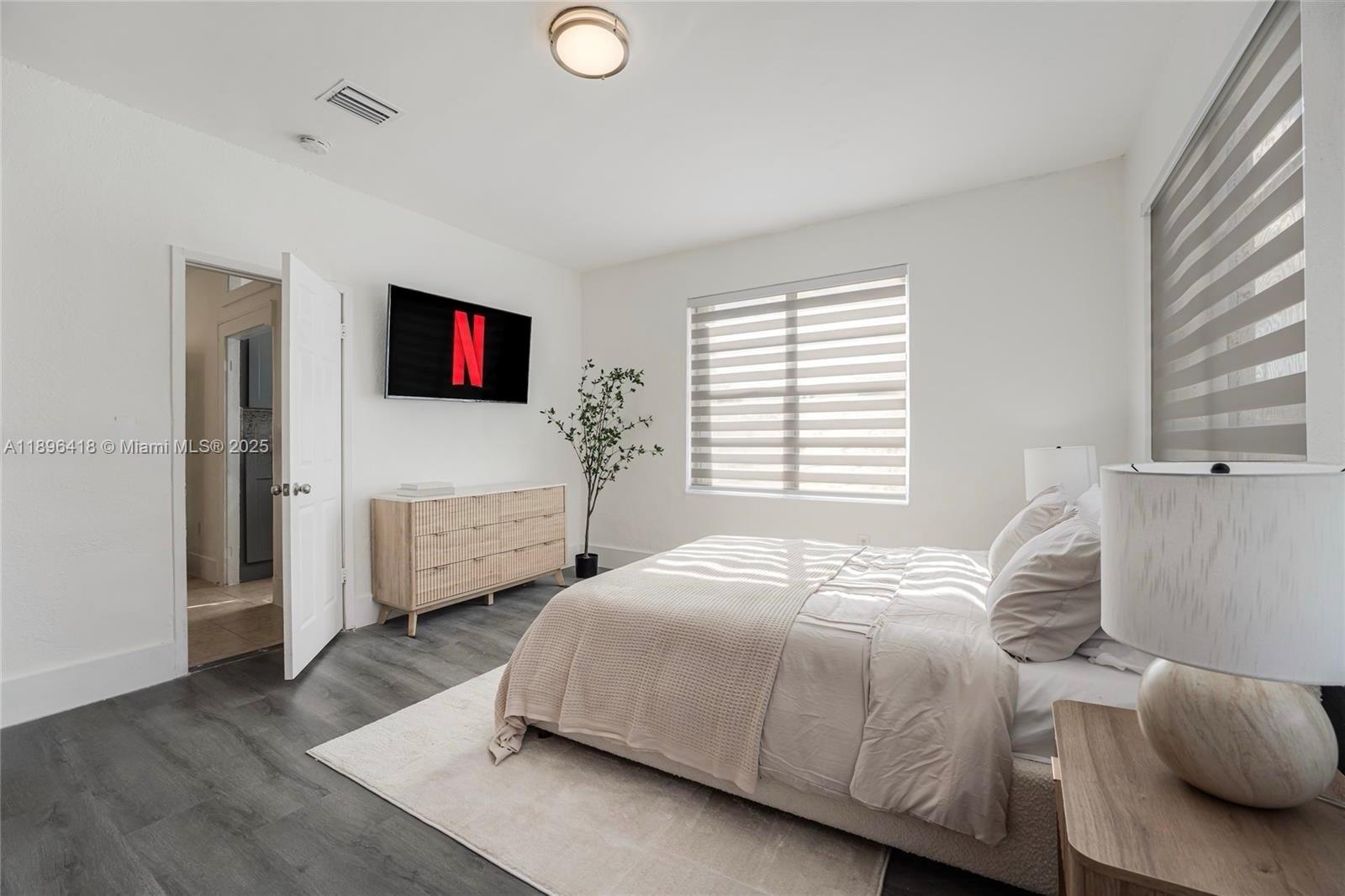 301 Southwest 10th Avenue, Unit 8 Miami, FL 33130 - Photo 9 of 14 a bedroom with a bed and a flat screen tv
