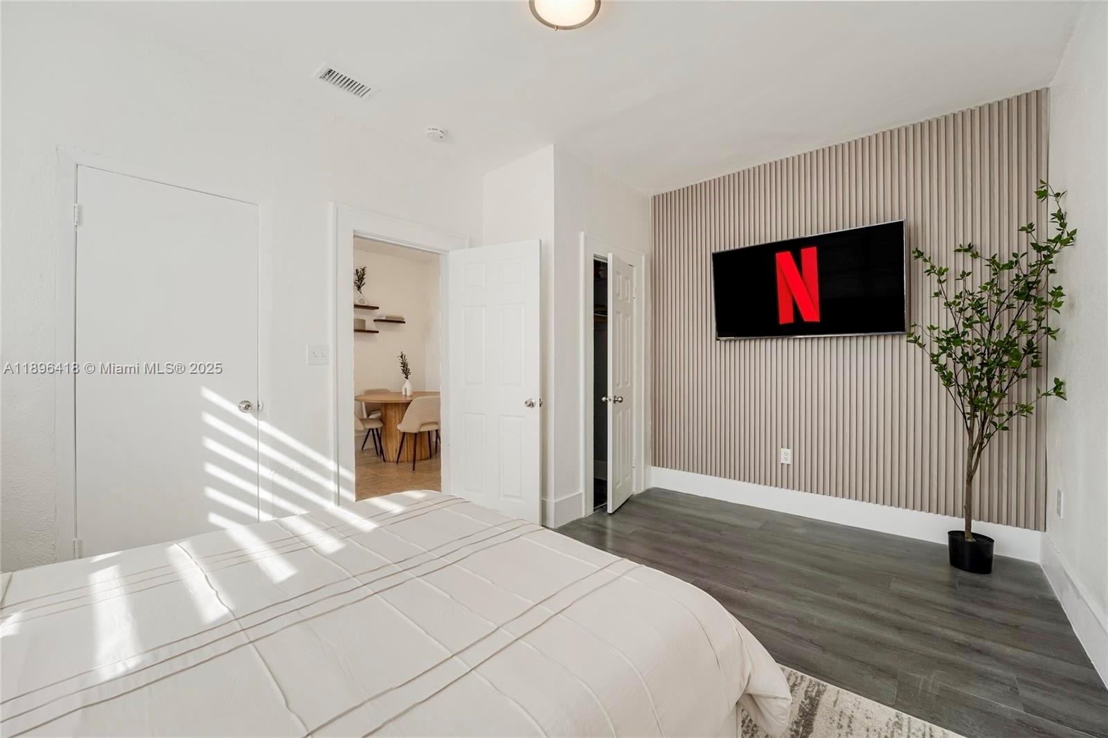 301 Southwest 10th Avenue, Unit 8 Miami, FL 33130 - Photo 10 of 14 a bedroom with a bed and a flat screen tv