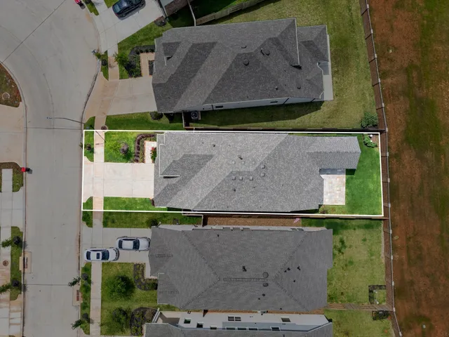 an aerial view of house with a yard