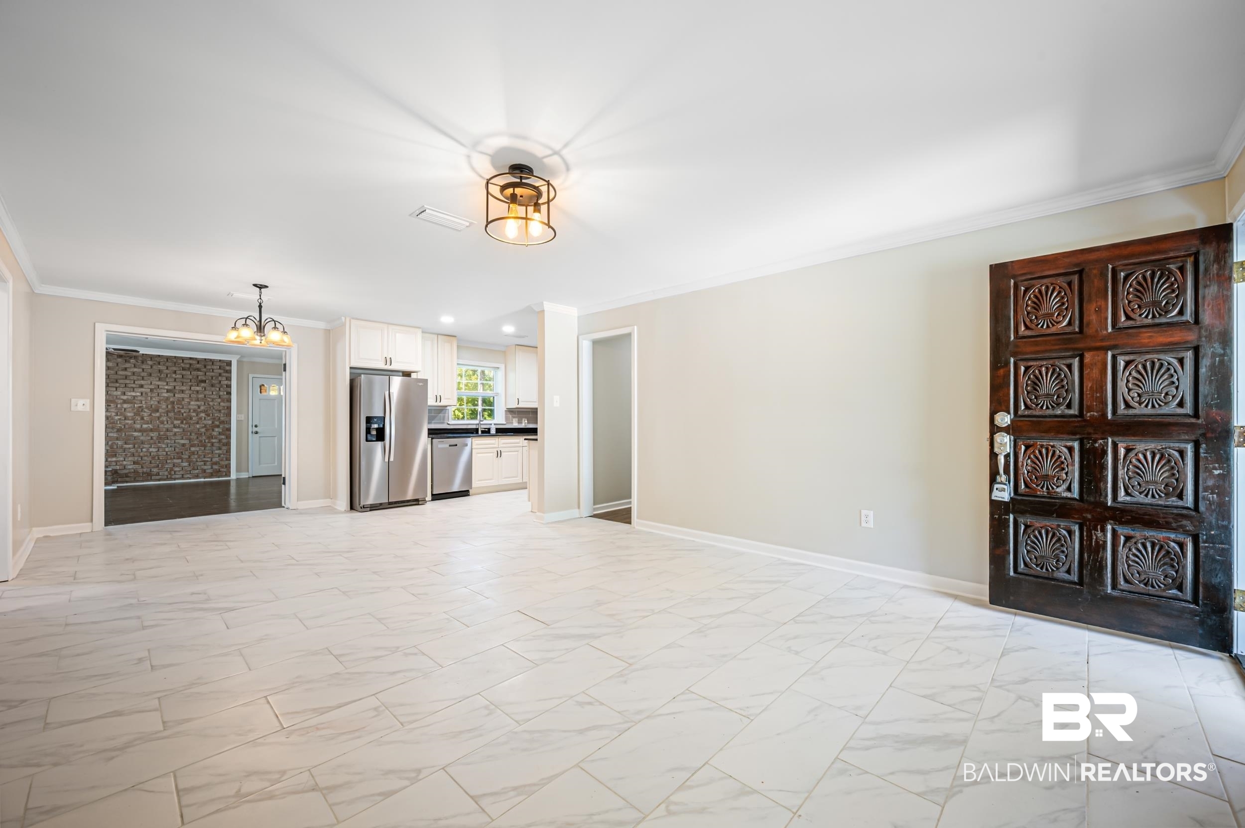 1605 Collier Avenue Bay Minette, AL 36507 - Photo 7 of 36 Unfurnished living room featuring a chandelier, crown molding, light marble finish floors, and recessed lighting