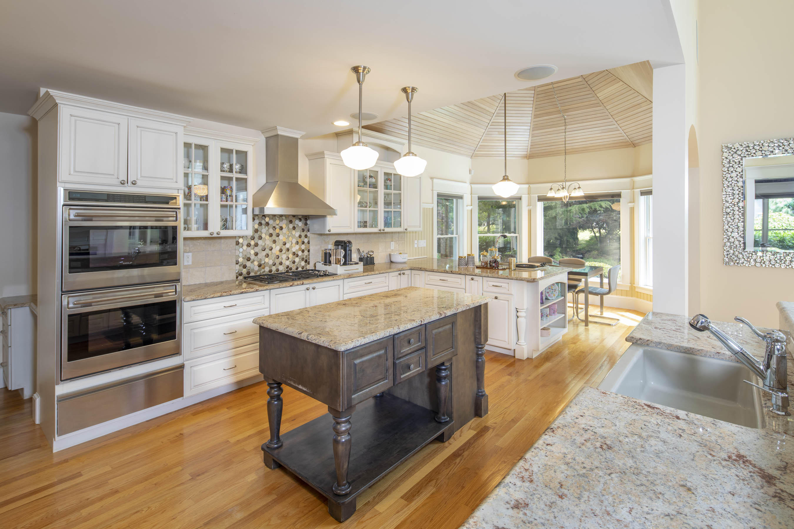 11 Reflection Drive Sandwich, MA 02563 - Photo 8 of 24 a view of a kitchen with kitchen island a large window a sink and cabinets