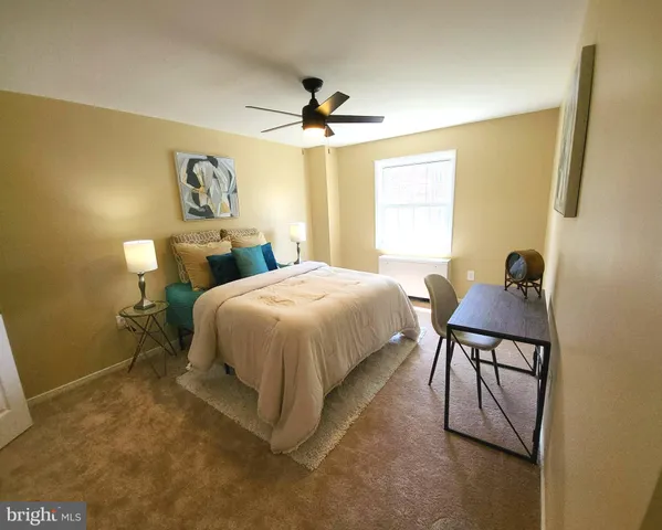 a bedroom with a bed and dresser with mirror