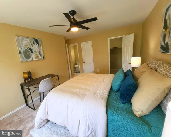 a bedroom with a bed and a painting on the wall