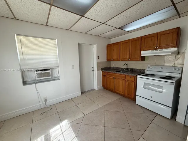 a kitchen with a stove a sink and a refrigerator