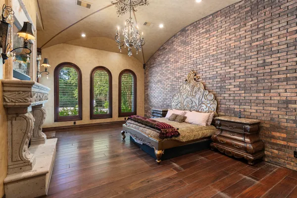 a living room with furniture a fireplace and a chandelier