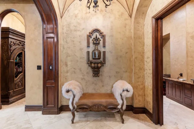 a kitchen with stainless steel appliances granite countertop a dining table and chairs in it