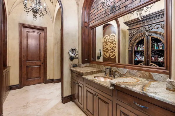 a kitchen with stainless steel appliances granite countertop a dining table and chairs in it