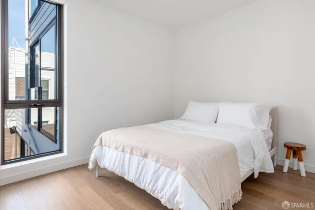 a bedroom with a bed and a view of kitchen