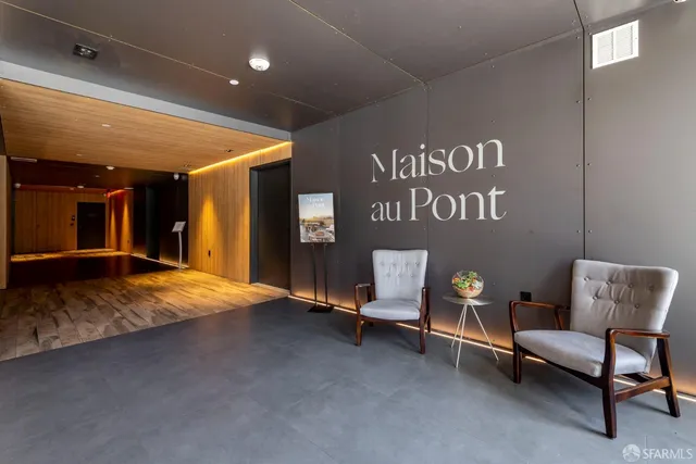 a kitchen with stainless steel appliances granite countertop a stove top oven a sink dishwasher a dining table and chairs with wooden floor