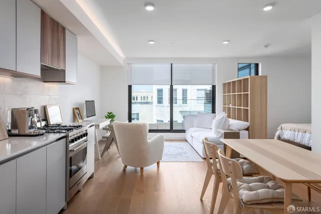 a kitchen with stainless steel appliances granite countertop a sink and a stove
