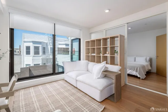 a large bed sitting in a bedroom next to a window