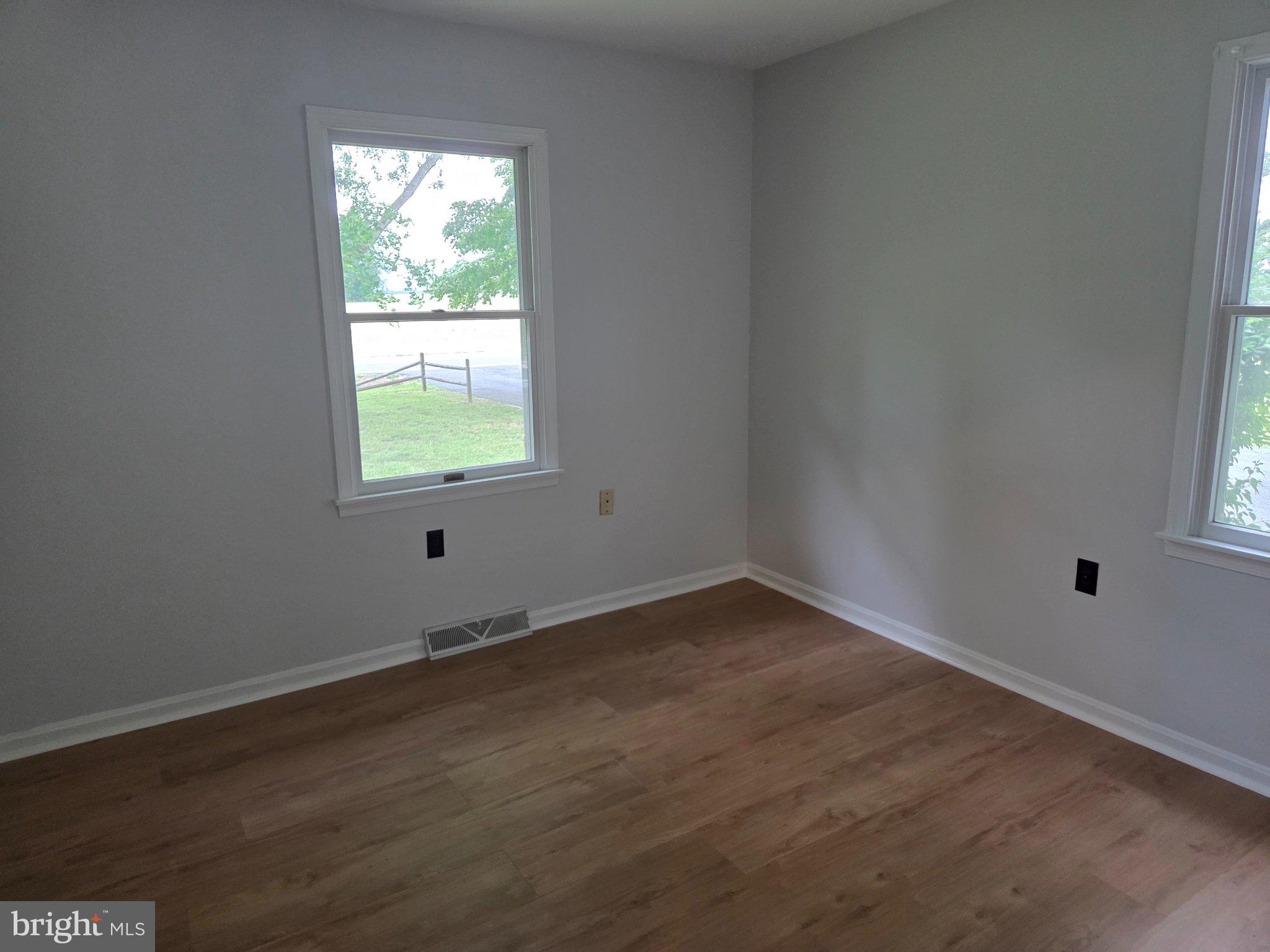 1378 Woodlytown Road Magnolia, DE 19962 - Photo 7 of 15 an empty room with wooden floor and windows