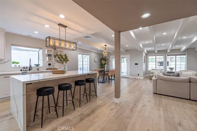 a large kitchen with a table and chairs