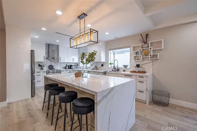 a kitchen with stainless steel appliances kitchen island a sink and cabinets