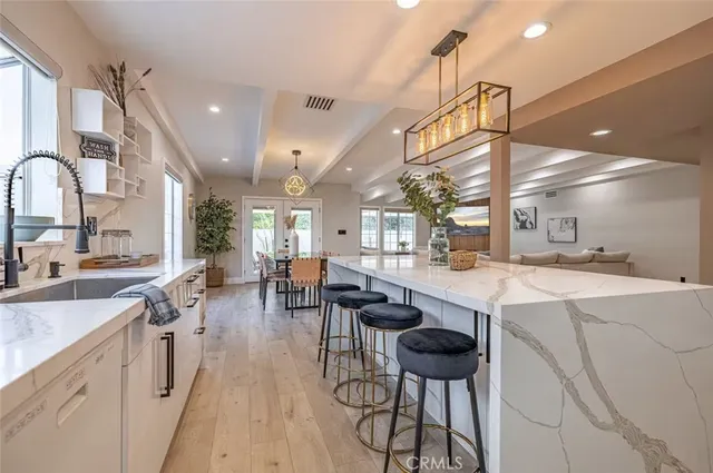a kitchen with lots of counter top space and furniture