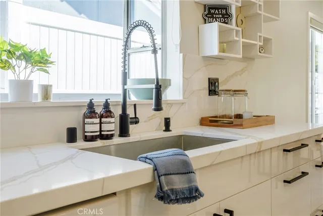 a kitchen with a sink and a large window