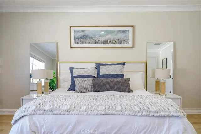 a bedroom with a bed and wooden floor