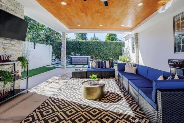 a view of a patio with couches chairs and a potted plant