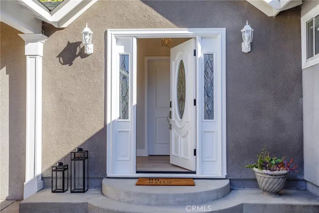 a view of a hallway with wooden floor and a potted plant