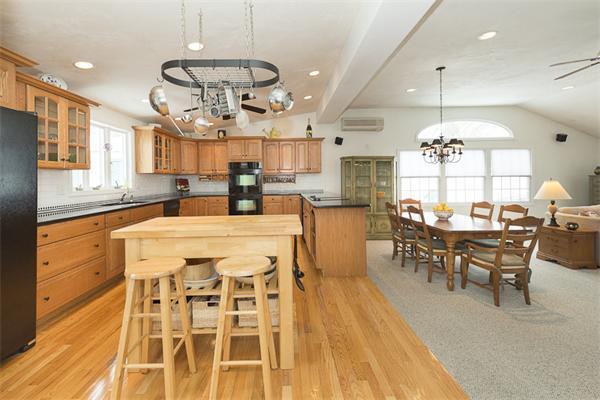 a large kitchen with a table and chairs in it