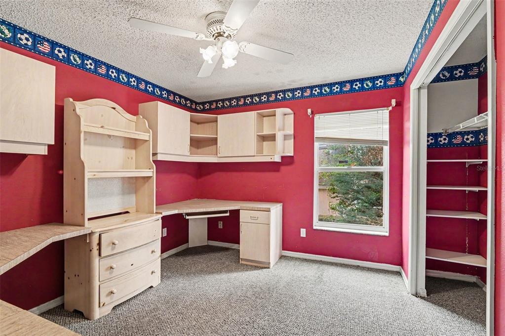 4716 Spaniel Street Orlando, FL 32818 - Photo 9 of 27 a spacious bedroom with a bed and a window