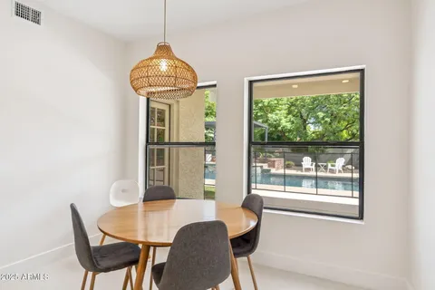 a dining room with furniture and window
