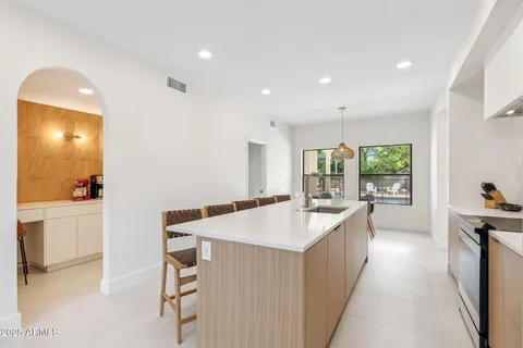 a large white kitchen with a large window