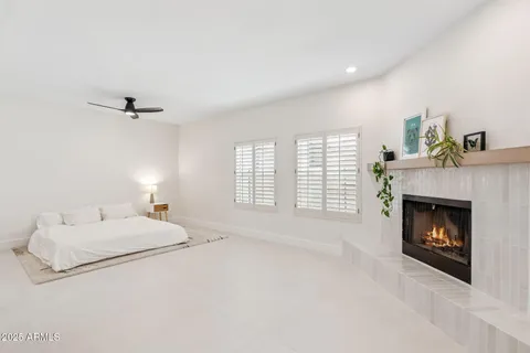 a spacious bedroom with a bed and a fireplace