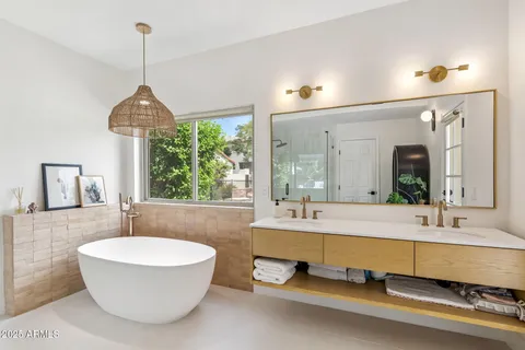 a spacious bathroom with a tub and sink