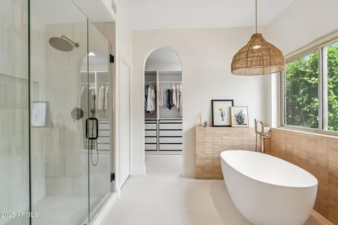 a spacious bathroom with a bathtub and window