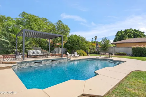 a view of a swimming pool with a lounge chair