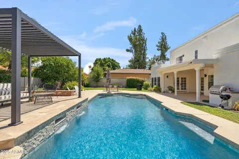 a swimming pool with outdoor seating and yard