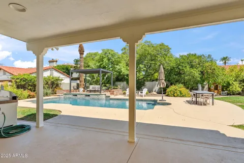 a view of a swimming pool with a patio