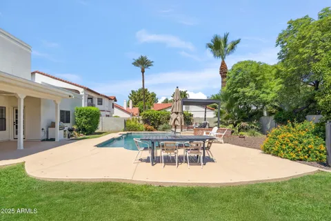 a view of a house with a swimming pool and sitting area