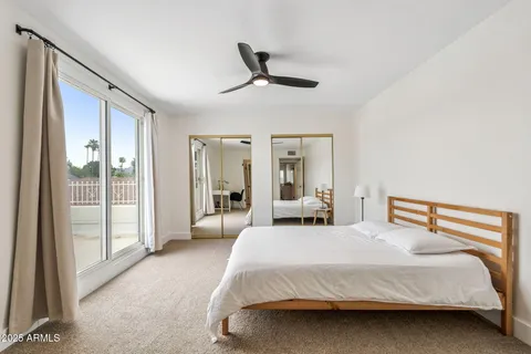 a bedroom with a large bed and a large window