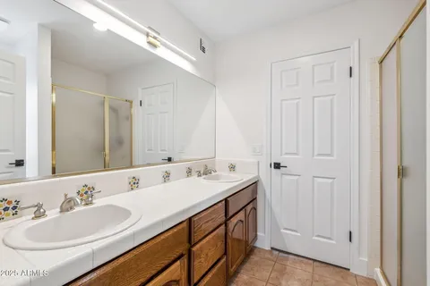 a bathroom with 2 sink and a mirror