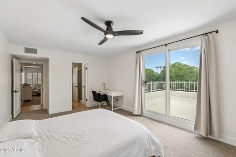 a bedroom with a large bed and a large window