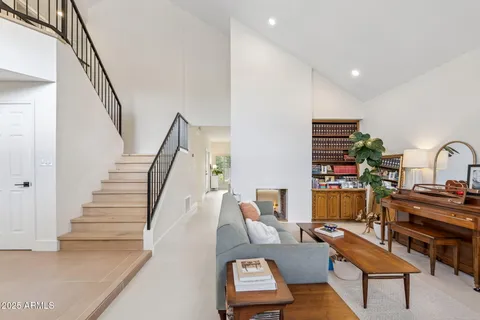 a living room with furniture and a chandelier
