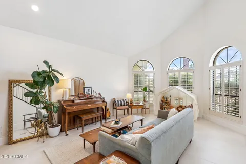 a living room with furniture a fireplace and a floor to ceiling window
