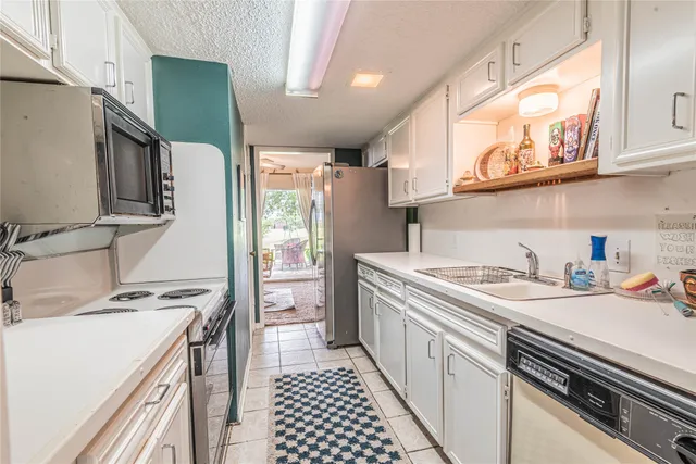 a kitchen with a sink stove and refrigerator