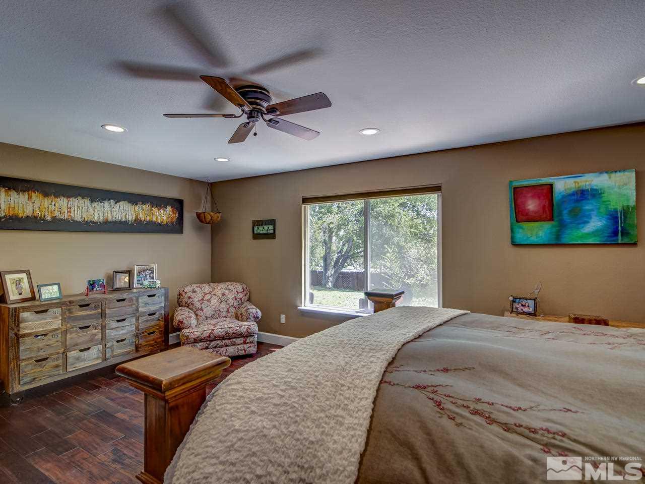 14410 Ghost Rider Drive Reno, NV 89511 - Photo 14 of 25 a bedroom with a bed and furniture