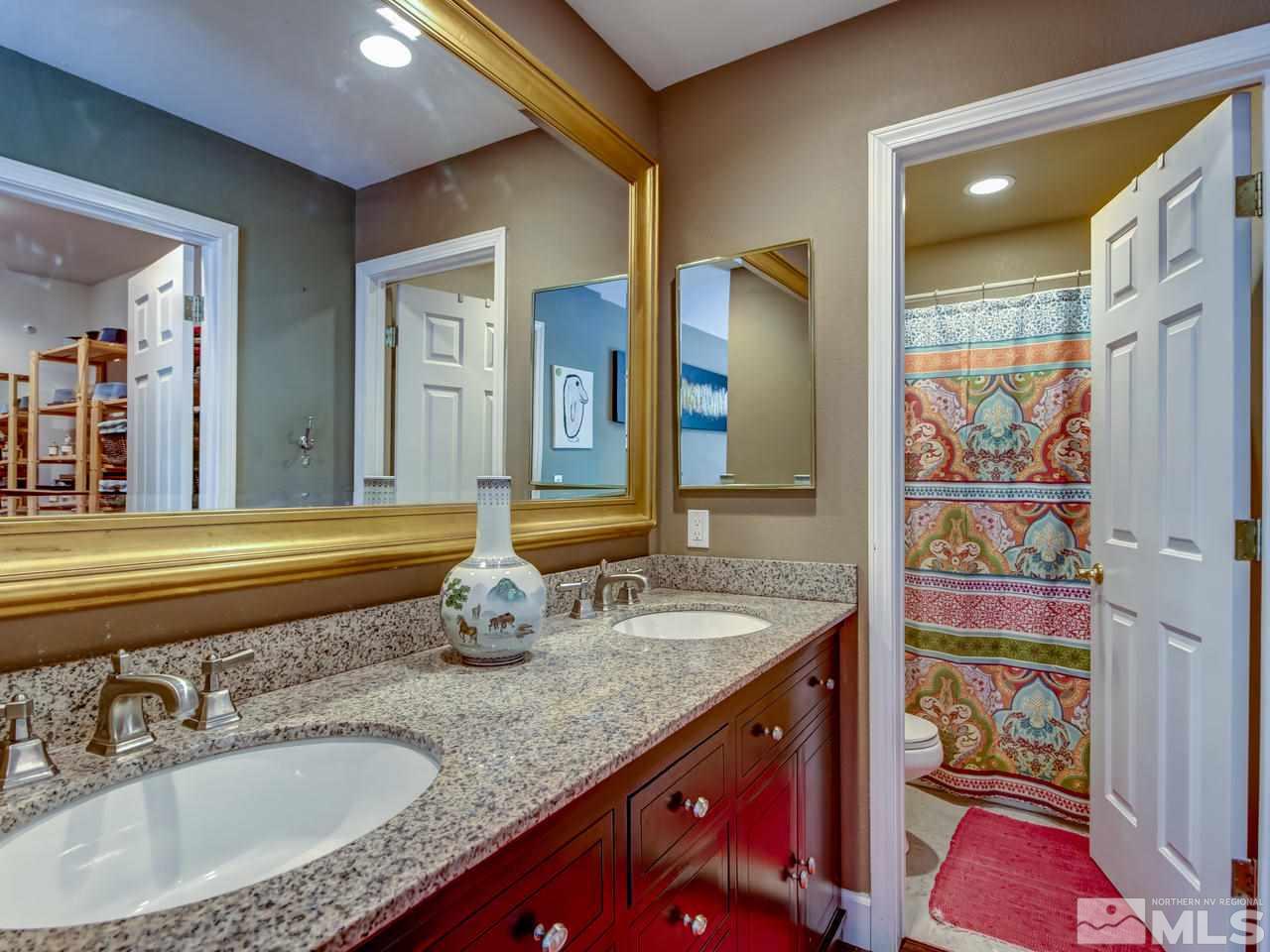 14410 Ghost Rider Drive Reno, NV 89511 - Photo 15 of 25 a bathroom with a granite countertop sink and a mirror