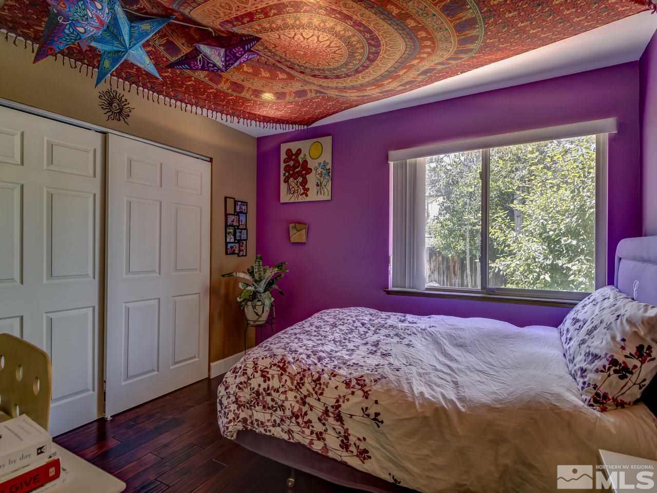 14410 Ghost Rider Drive Reno, NV 89511 - Photo 16 of 25 a bed sitting in a bedroom next to a window