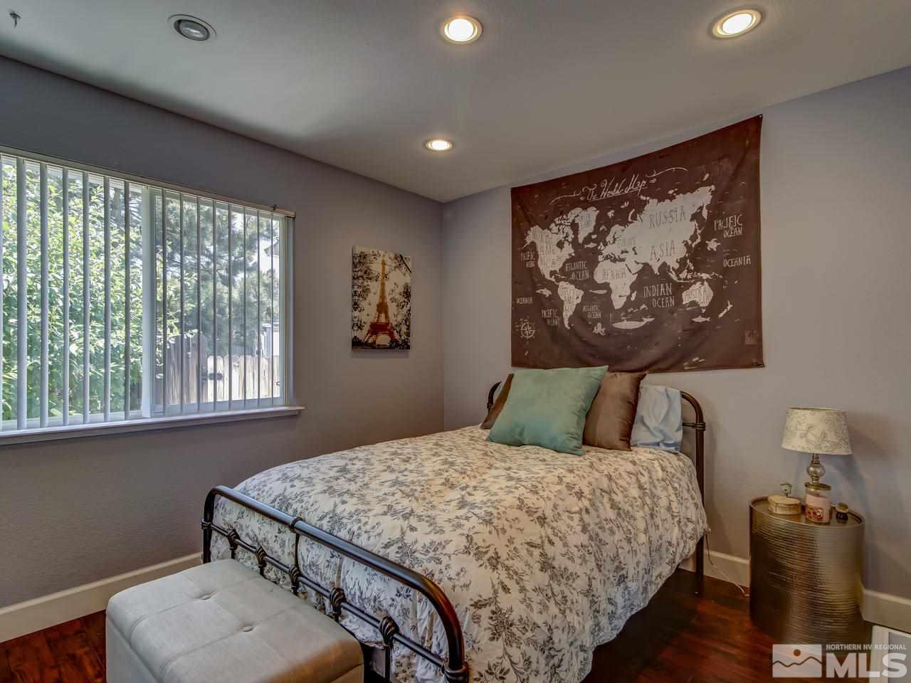 14410 Ghost Rider Drive Reno, NV 89511 - Photo 17 of 25 a bedroom with a large bed and a window